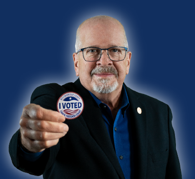 Craig Latimer holding I Voted Sticker